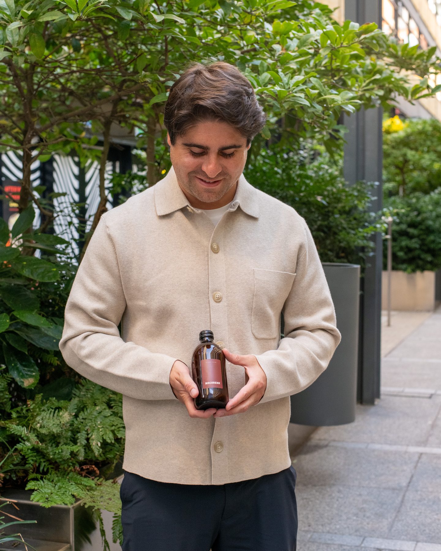 Javier, Macarena’s founder, holding a bottle of Macarena concentrate in both hands
