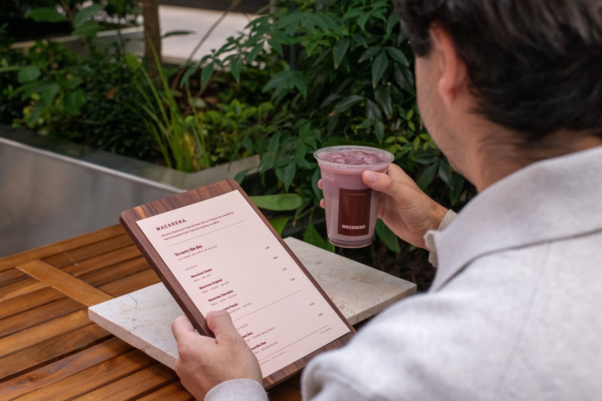 Reading the Macarena menu at an outdoor table